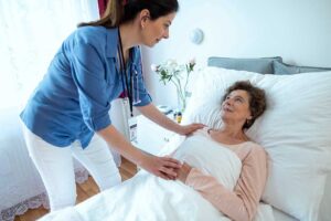 Family members review care documents with an assisted living staff member at a resident’s table.